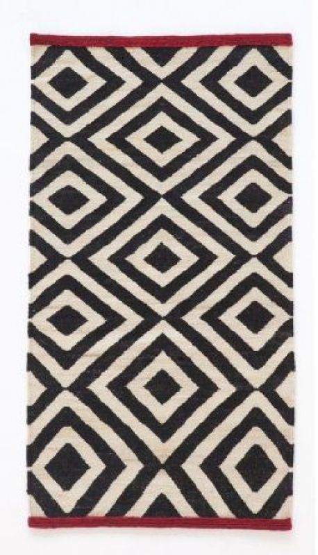 Nanimarquina Teppich mit grafischem Rautenmuster in Schwarz und Beige, roter Rand. Moderner Teppich für Wohnräume.